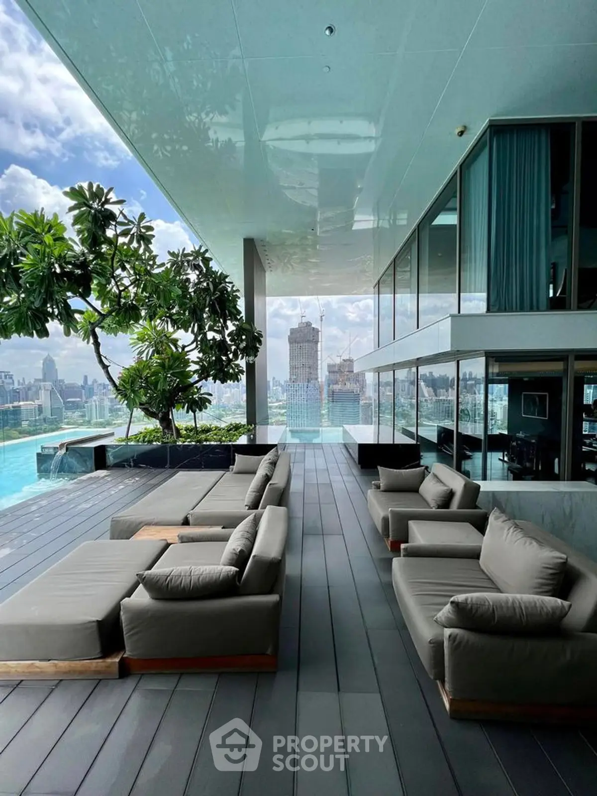 Luxurious rooftop terrace with stunning city view and modern outdoor seating.