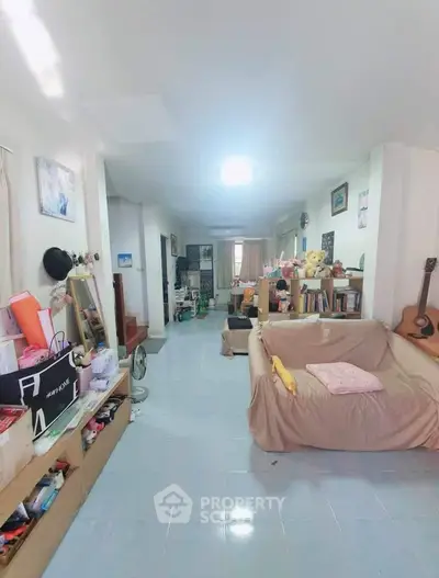 Spacious living room with cozy decor and ample natural light, perfect for family gatherings.