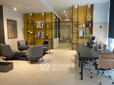Modern living room with stylish decor and open layout, featuring contemporary furniture and elegant shelving.