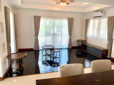 Spacious living room with modern furniture and large windows for natural light.