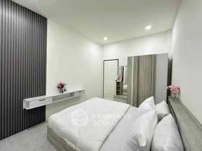 Modern bedroom with sleek design, featuring a cozy bed, stylish wardrobe, and elegant decor.
