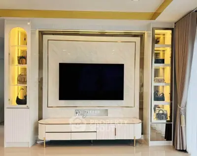 Luxurious living room with modern TV setup and elegant shelving