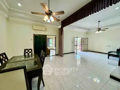 Spacious open-plan living and dining area with elegant ceiling fans and natural light.