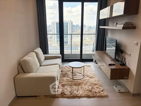 Modern living room with city view, cozy sofa, and stylish decor in high-rise apartment.