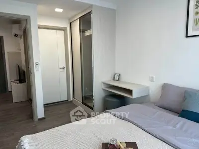 Modern bedroom with sleek design and cozy ambiance, featuring a comfortable bed and stylish decor.