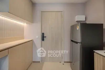 Modern kitchen with sleek cabinetry and stainless steel fridge