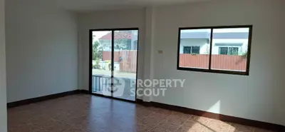 Spacious unfurnished room with large windows and sliding glass door, perfect for customization.