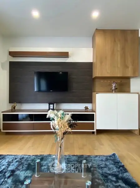 Modern living room with stylish TV unit and wooden flooring