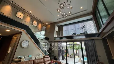 Luxurious modern living room with high ceiling and pool view, featuring elegant lighting and stylish decor.