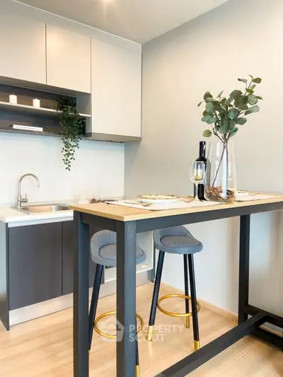 Modern kitchen with sleek design, featuring a stylish breakfast bar and contemporary decor.