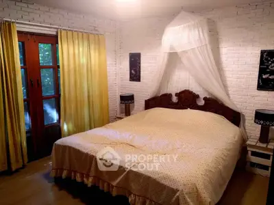 Charming bedroom with rustic brick walls and elegant wooden bedframe