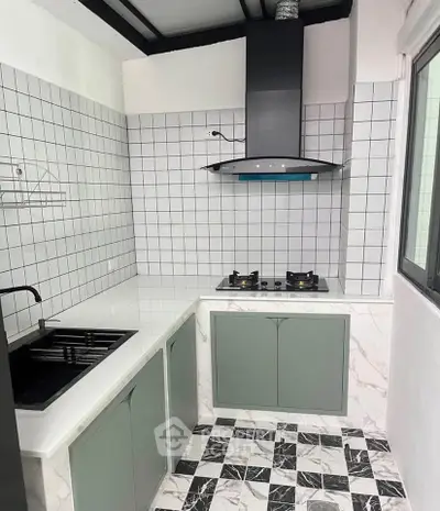 Modern kitchen with sleek design, featuring gas stove and stylish cabinetry, perfect for culinary enthusiasts.