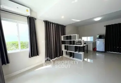 Spacious modern living room with large windows and sleek furnishings
