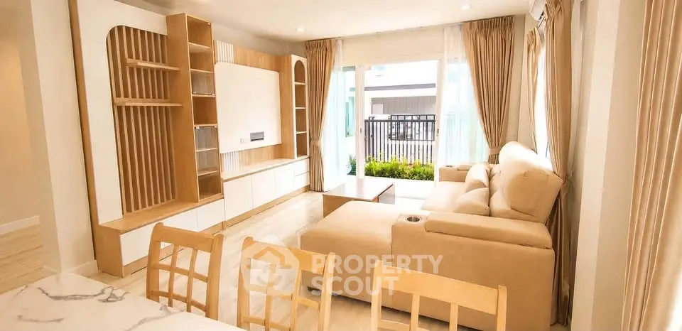 Spacious living room with modern furniture and large windows offering natural light.
