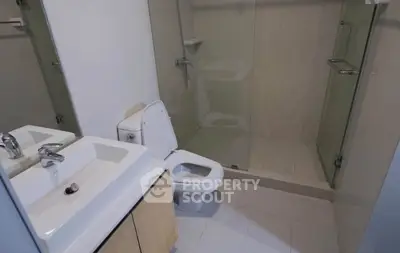 Modern bathroom with glass shower and sleek fixtures in a contemporary home.