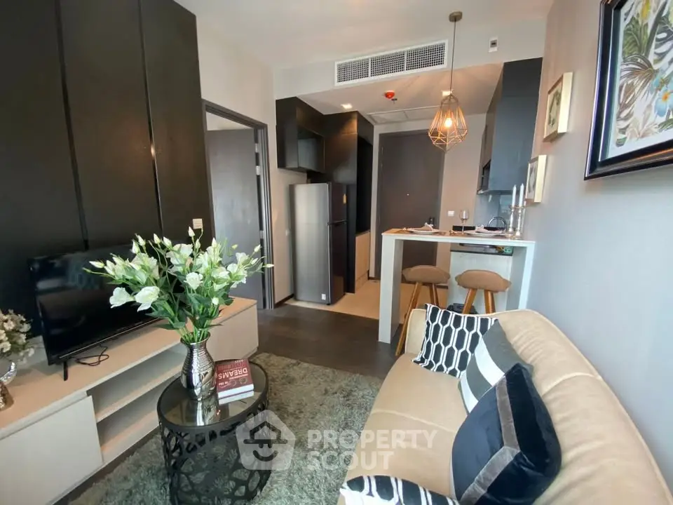 Modern living room with stylish decor and open kitchen layout in a contemporary apartment.