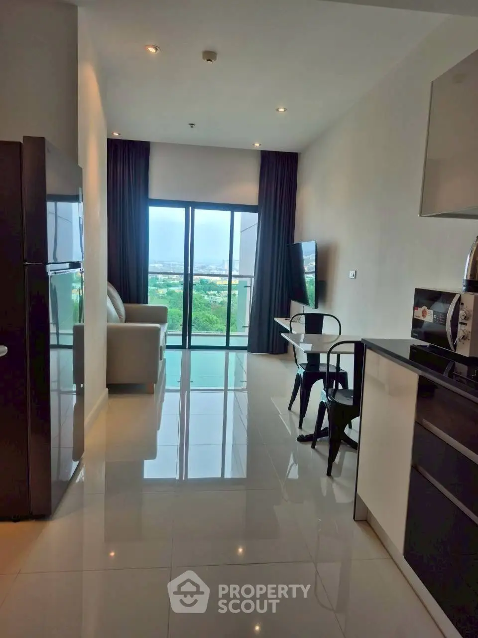 Modern living room with sleek design and stunning view from balcony.