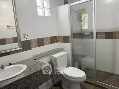 Modern bathroom with glass shower and granite countertop