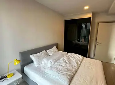 Modern bedroom with stylish decor and cozy ambiance, featuring a comfortable bed and sleek furnishings.