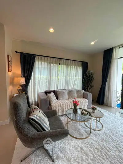 Elegant living room with plush seating, stylish decor, and large windows for natural light.