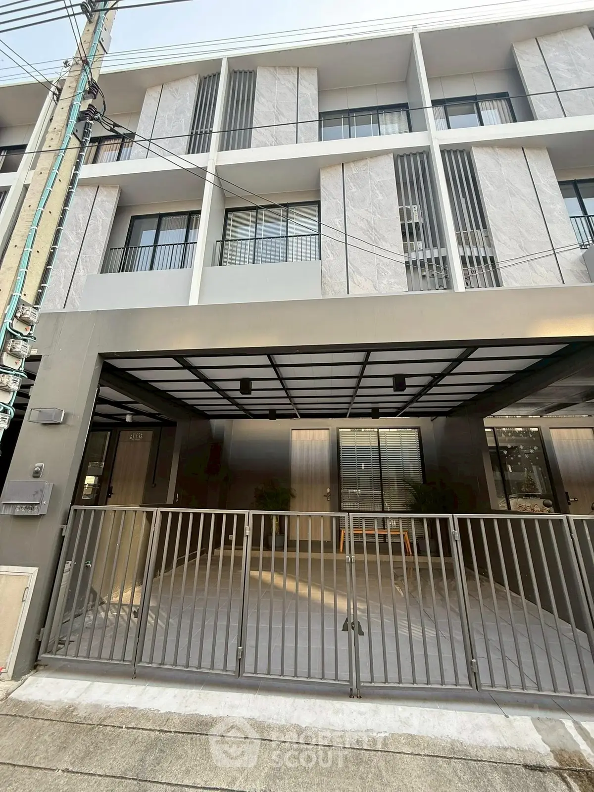 Modern townhouse exterior with gated entrance and sleek design