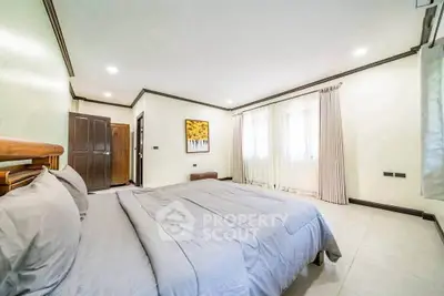 Spacious and bright bedroom with elegant decor and large windows for natural light.