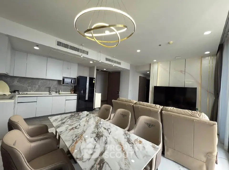 Luxurious open-plan living room with modern kitchen and elegant marble dining table.