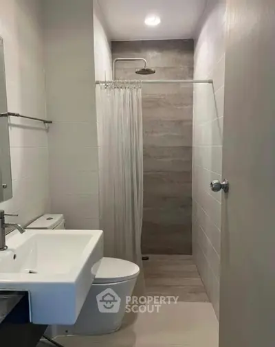 Modern bathroom with sleek fixtures and walk-in shower design.