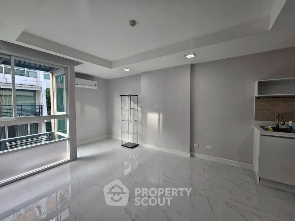 Modern unfurnished apartment with marble flooring and large windows