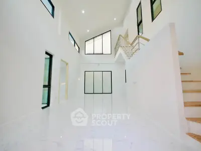 Spacious modern living room with high ceilings and large windows