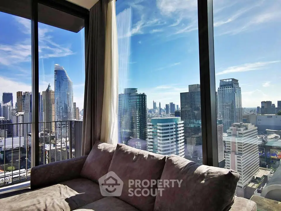 Luxurious living room with stunning city skyline view from high-rise apartment.