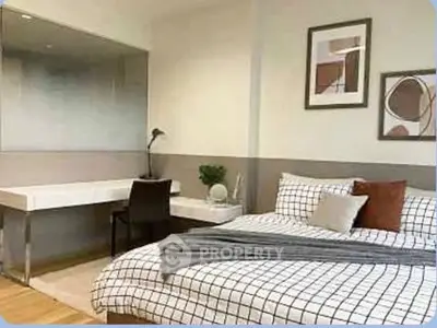 Modern bedroom with stylish decor and cozy workspace in a contemporary apartment.