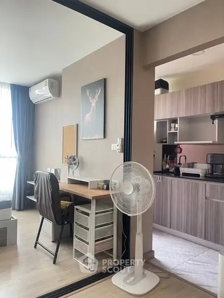 Modern apartment interior with stylish kitchen and cozy study area, featuring sleek furniture and natural light.