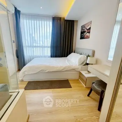 Cozy modern bedroom with city view, featuring elegant decor and natural light.