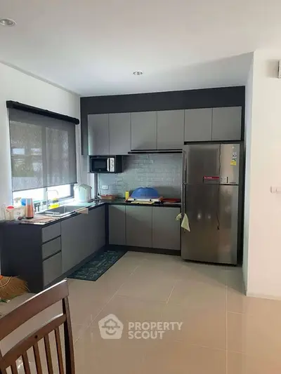 Modern kitchen with sleek cabinetry and stainless steel fridge