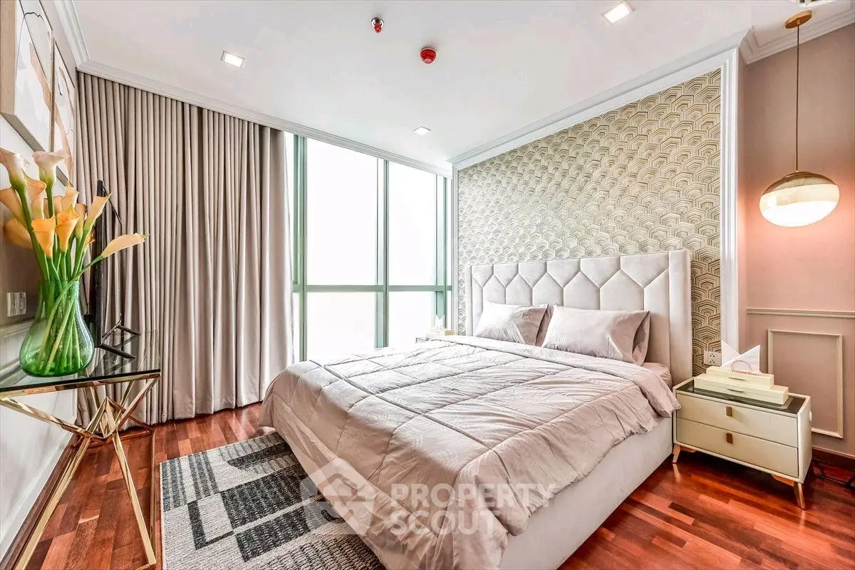 Luxurious bedroom with elegant decor, large window, and stylish furnishings in a modern apartment.