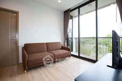 Modern living room with large windows and balcony view, featuring a cozy brown sofa and sleek flooring.