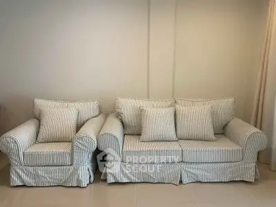 Elegant striped sofa set in a modern living room, perfect for stylish comfort.