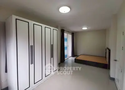 Spacious bedroom with modern wardrobe and large window