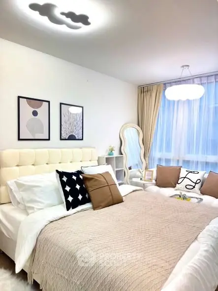 Elegant bedroom with modern decor and cozy ambiance, featuring stylish lighting and plush bedding.