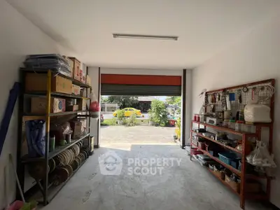 Spacious garage with organized shelving and open view to driveway