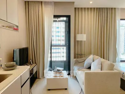 Modern living room with cozy sofa and large windows in a stylish apartment.