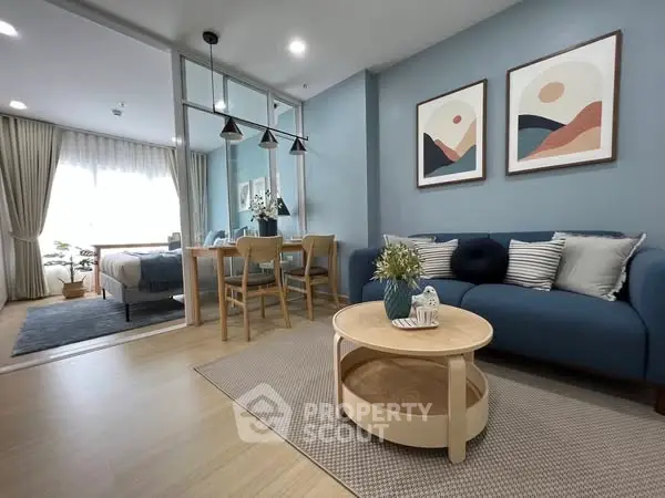 Modern living room with stylish decor and open layout, featuring cozy seating and elegant dining area.