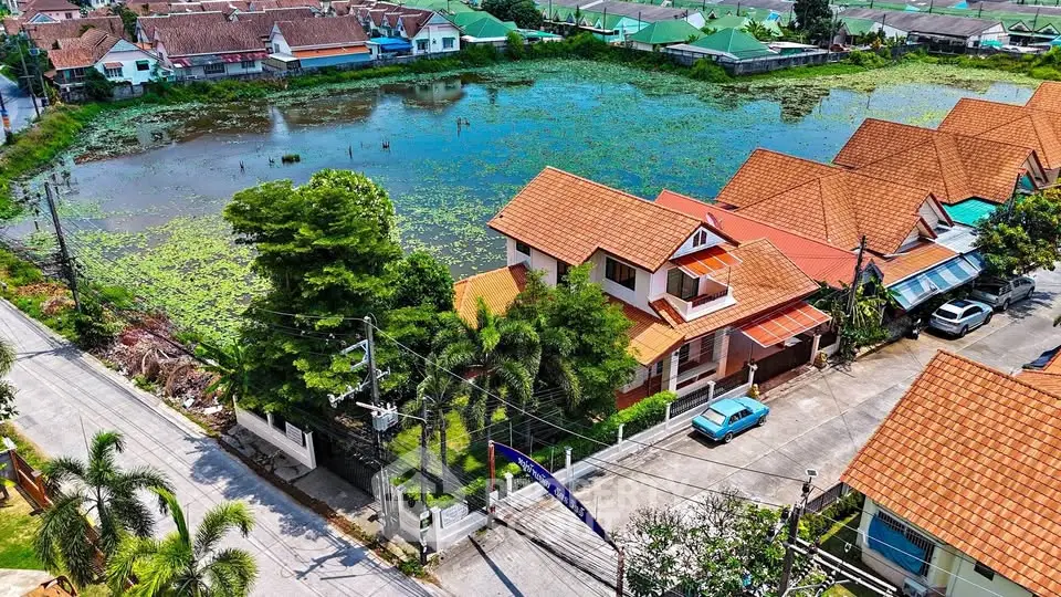 Charming residential area with scenic pond view and traditional architecture.