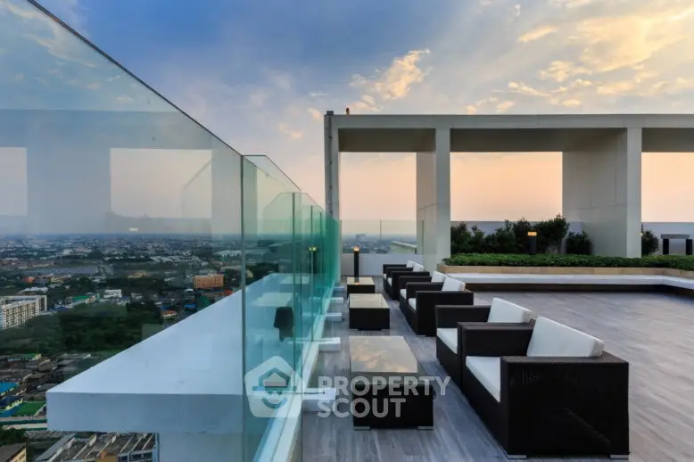 Luxurious rooftop terrace with stunning city views and modern seating area at sunset.