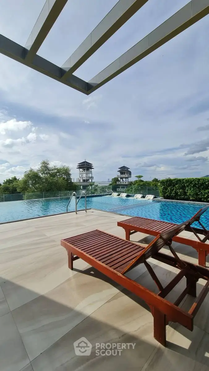 Luxurious rooftop pool with stunning views and elegant lounge chairs, perfect for relaxation and leisure.