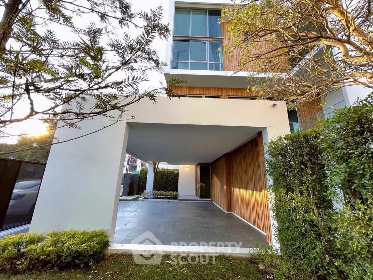 Modern architectural exterior with sleek design and lush greenery, perfect for contemporary living.
