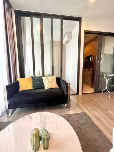 Modern living room with stylish sofa and glass partition, open layout design