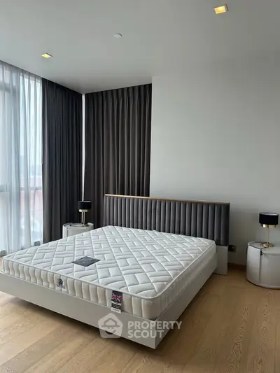 Modern bedroom with stylish bed and floor-to-ceiling windows in luxury apartment.