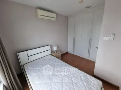 Cozy bedroom with built-in wardrobe and air conditioning, perfect for restful nights.